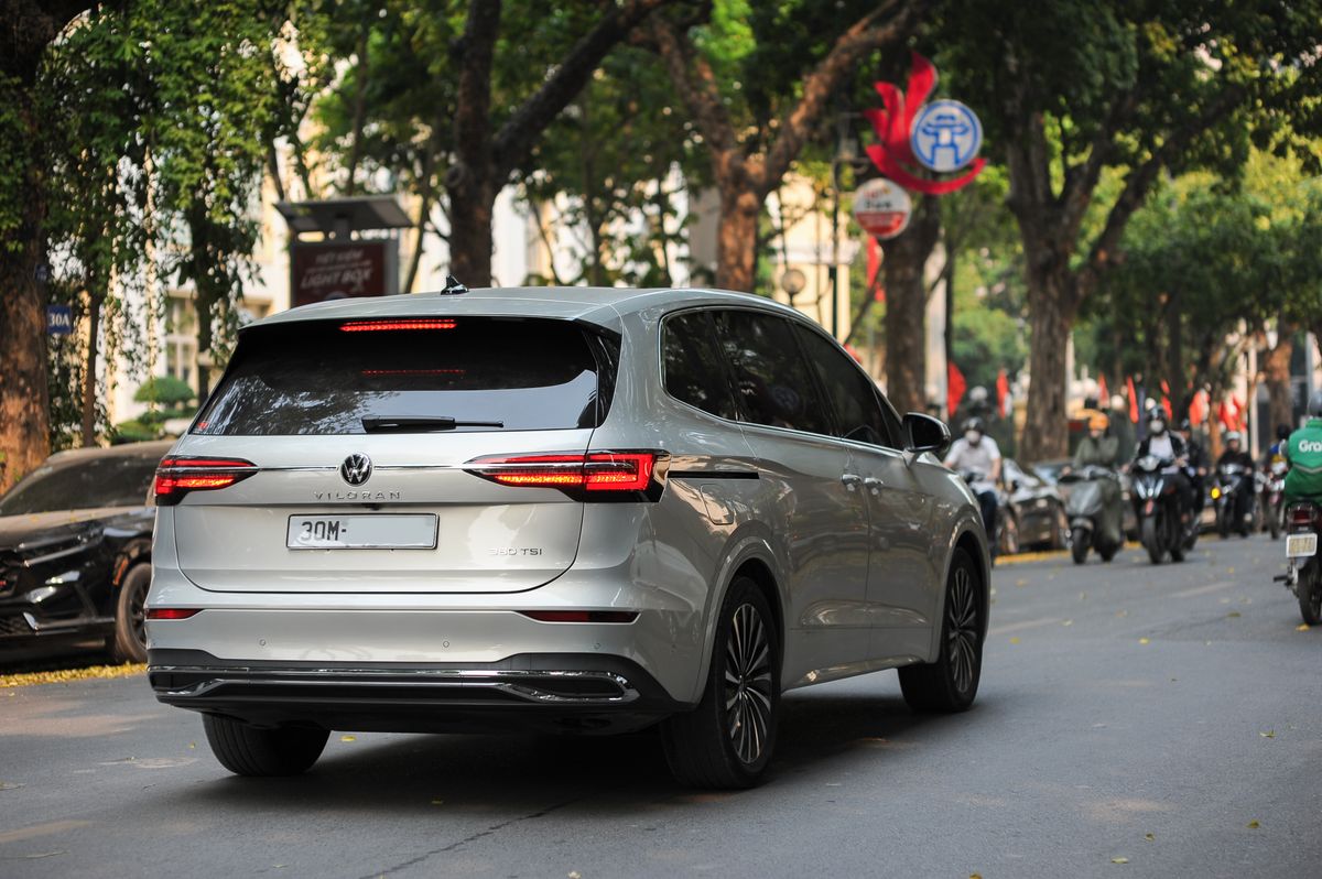 Modern premium MPV on a tree-lined street